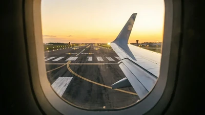 Airplane window view of runway during landing for China port visa guide